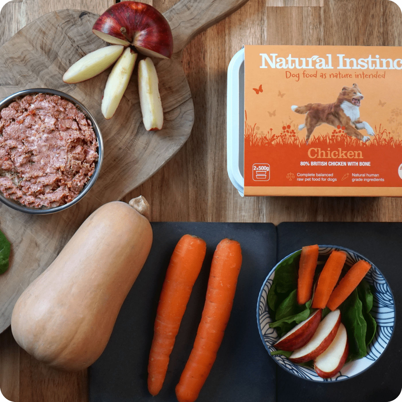 Natural Instinct's raw Natural Chicken recipe positioned on a wooden table with the ingredients surrounding the product