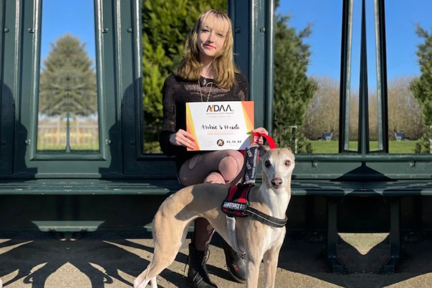 Girl with her dog and an award from The Assistance Dog Assessment Association